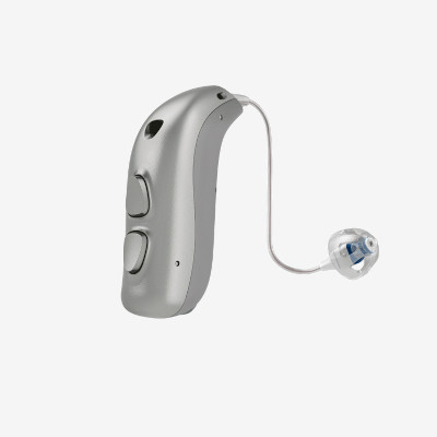 A silver behind-the-ear hearing aid with two buttons and a thin wire leading to a small, clear earpiece with a blue accent, shown on a plain white background.